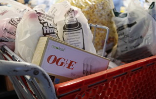 A box of donated OG&E bulbs sits in a basket full of food from a shopper at the Regional Food Bank of Oklahoma's Food & Resource Center.