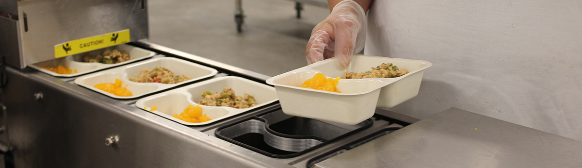 A Regional Food Bank staff member packages Senior Servings meals.