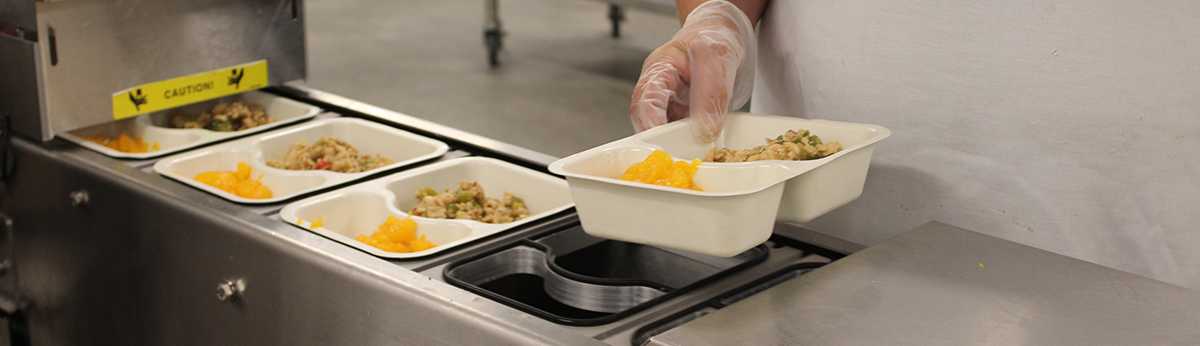Senior Servings Banner A Regional Food Bank staff member packages Senior Servings meals.