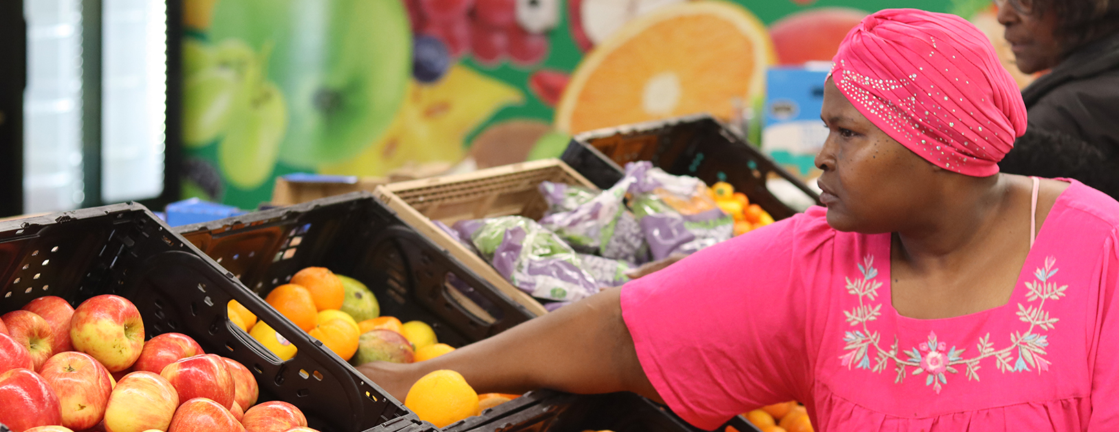 FRC Volunteer Banner A woman shops at the Regional Food Bank FRC.