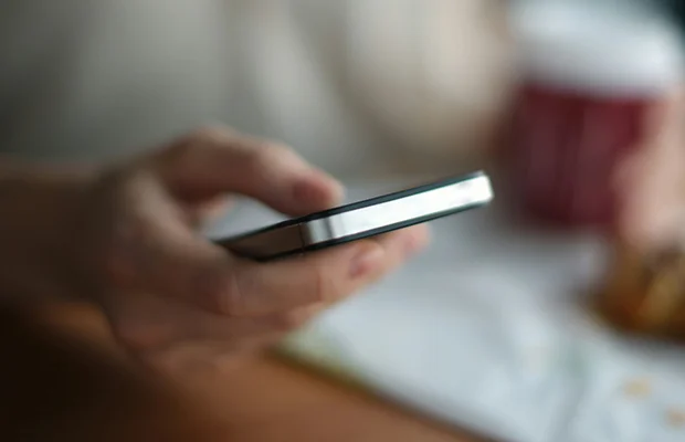 Image of person holding a mobile phone.